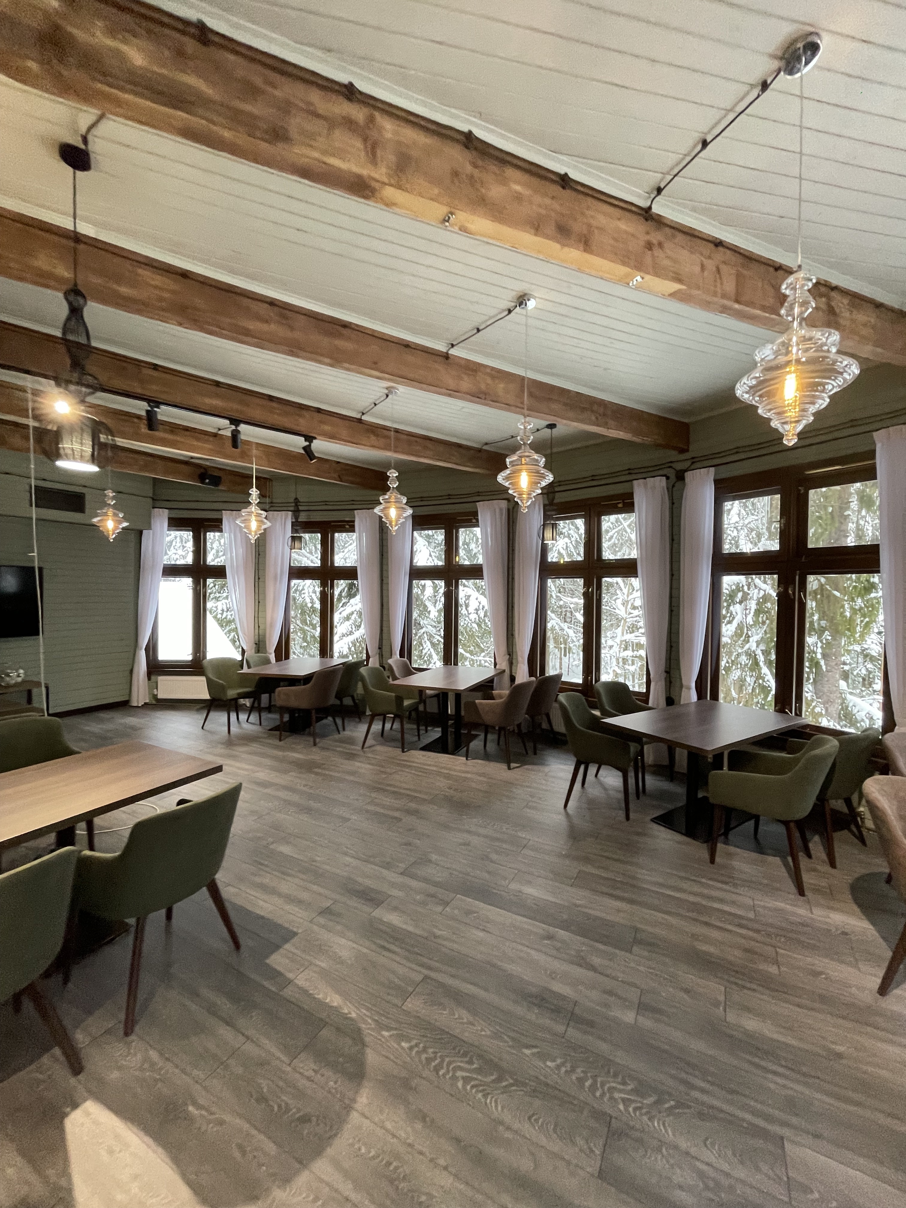 Restaurant interior with walnut panelling and pendant lighting